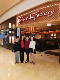 The training team of The Cheesecake Factory taking a photo in front of a restaurant in Macao during its opening in October 2019. 